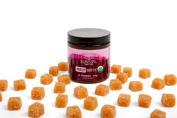 Jar of Sunsoil berry gummies with gummies displayed around jar