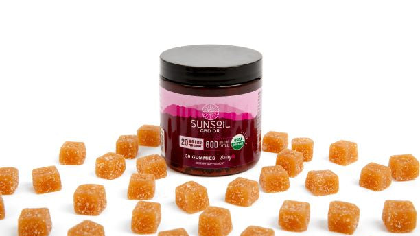 Jar of Sunsoil berry gummies with gummies displayed around jar