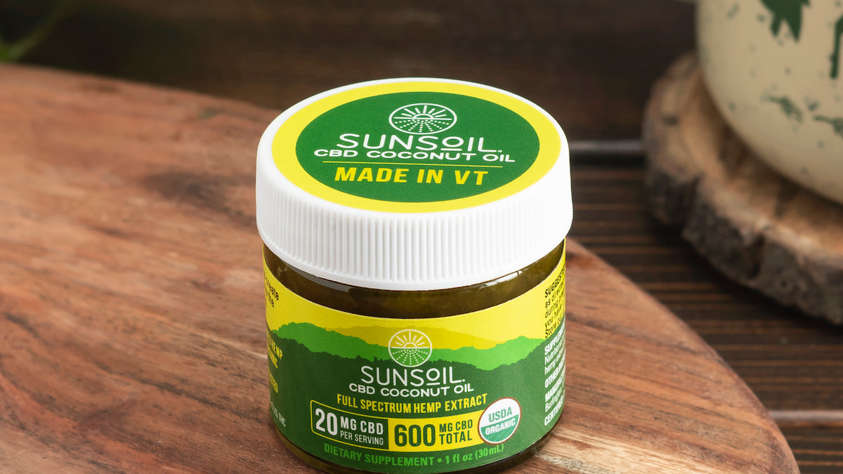 Sunsoil Coconut Oil on a wooden table.